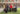 Las supervivientes por la abolición, en el jardín del Instituto Internacional. De pie, de izquierda a derecha: Amelia Tiganus, Rachel Moran, Claudia Quintero, Lydia Osifo, Rosen Hicher y Karola de la Cuesta. Sentadas, a la izquierda, Alika Kinan, en la mesa, Ally-Marie Diamond, y Susan Andrea Avella.